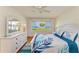 Comfortable bedroom features a large window showcasing serene lake views, plus calming decor at 4736 Independence Dr # 4736, Bradenton, FL 34210