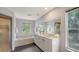 Elegant bathroom featuring a soaking tub, walk-in shower, and double sink vanity at 4771 Riverwood Cir, Sarasota, FL 34231