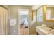 Bathroom view into bedroom with hardwood floors, natural light, closet at 4771 Riverwood Cir, Sarasota, FL 34231