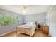 Cozy bedroom with hardwood floors, a large window, and closet at 4771 Riverwood Cir, Sarasota, FL 34231