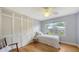 Quaint bedroom with hardwood floors, ample natural light, and a closet at 4771 Riverwood Cir, Sarasota, FL 34231
