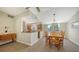 Dining area with an open view of the kitchen, tile floors, and a window overlooking the backyard at 4771 Riverwood Cir, Sarasota, FL 34231