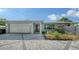 Charming single-story home with a well-maintained front yard, brick driveway, and attached garage at 4771 Riverwood Cir, Sarasota, FL 34231