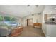 Open-concept living room with tile flooring, neutral walls, and a glimpse of the kitchen area at 4771 Riverwood Cir, Sarasota, FL 34231