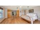 Spacious main bedroom with hardwood floors, a king bed and double doors at 4771 Riverwood Cir, Sarasota, FL 34231