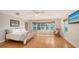 Bright main bedroom with hardwood floors, large windows, rocking chair, and king bed at 4771 Riverwood Cir, Sarasota, FL 34231