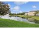 Beautiful lake view from the backyard with fountain, enhanced with lush green landscaping at 4833 San Palermo Dr, Bradenton, FL 34208