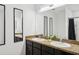 Bathroom with a double sink vanity, dark cabinets, and a granite countertop at 4833 San Palermo Dr, Bradenton, FL 34208