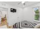 Inviting bedroom with a ceiling fan, window, and en suite bathroom at 4833 San Palermo Dr, Bradenton, FL 34208