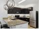 Stylish kitchen boasts granite counters, stainless appliances, and pendant lighting at 4833 San Palermo Dr, Bradenton, FL 34208