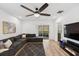 Bright living room with sectional sofa, sliding doors leading to a patio, and modern entertainment center at 4833 San Palermo Dr, Bradenton, FL 34208