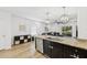 Open concept living area with kitchen island, stainless appliances, and dark cabinetry at 4833 San Palermo Dr, Bradenton, FL 34208