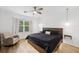 Serene main bedroom with natural light, ceiling fan, rocking chair, and a cozy bed at 4833 San Palermo Dr, Bradenton, FL 34208