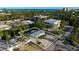 Beautiful aerial view showcasing the home, street, and nearby buildings with an ocean view in the background at 5026 Calle Minorga, Sarasota, FL 34242