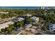 Property aerial view showing rooftops and tree coverage around homes at 5026 Calle Minorga, Sarasota, FL 34242
