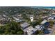 High-angle aerial showcasing the property surrounded by homes and buildings, with the ocean visible in the distance at 5026 Calle Minorga, Sarasota, FL 34242