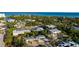 Stunning aerial view of property surrounded by lush greenery, highlighting its prime location near the ocean at 5026 Calle Minorga, Sarasota, FL 34242