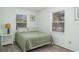 Calm bedroom with green walls, comfortable bed and windows for natural light at 5026 Calle Minorga, Sarasota, FL 34242