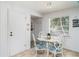 Bright breakfast nook featuring a glass table and four chairs next to a window at 5026 Calle Minorga, Sarasota, FL 34242