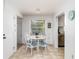 Bright dining area featuring a glass-top table and white chairs near a window at 5026 Calle Minorga, Sarasota, FL 34242