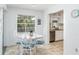 Bright dining area with a glass-top table and seating for four, showcasing natural light and tile flooring at 5026 Calle Minorga, Sarasota, FL 34242