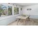 Bright dining room with large windows and a long, light-colored table at 5026 Calle Minorga, Sarasota, FL 34242