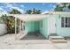 Exterior shot of a home featuring a covered carport and a white front door at 5026 Calle Minorga, Sarasota, FL 34242