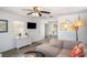 Bright living room featuring a comfortable sofa, ceiling fan, and view into the dining area at 5026 Calle Minorga, Sarasota, FL 34242