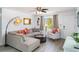 Comfortable living room with a sectional sofa, ceiling fan, and large windows, offering a relaxing space at 5026 Calle Minorga, Sarasota, FL 34242