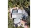 An overhead view of a home featuring a screened pool, lush landscaping, and a gray roof at 5353 Shadow Lawn Dr, Sarasota, FL 34242