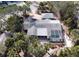 Aerial view of home with screened in pool and mature landscaping in Siesta Isles at 5353 Shadow Lawn Dr, Sarasota, FL 34242