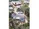 Aerial view of home with screened in pool and mature landscaping in Siesta Isles at 5353 Shadow Lawn Dr, Sarasota, FL 34242