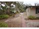 Lush backyard featuring vibrant plants, a brick path, and a view of the home at 5353 Shadow Lawn Dr, Sarasota, FL 34242