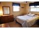 Traditional bedroom with a bed, dresser, and windows providing natural light at 5353 Shadow Lawn Dr, Sarasota, FL 34242