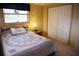 Bedroom featuring a bed, a nightstand with a lamp, and a closet at 5353 Shadow Lawn Dr, Sarasota, FL 34242