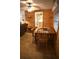 Dining area featuring wood paneling, tile floors, a wooden table, and views to the kitchen at 5353 Shadow Lawn Dr, Sarasota, FL 34242
