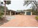 Spacious home with a brick driveway, covered parking, and a detached garage at 5353 Shadow Lawn Dr, Sarasota, FL 34242