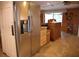 Kitchen area features stainless steel refrigerator and adjacent cabinetry at 5353 Shadow Lawn Dr, Sarasota, FL 34242