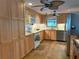 Well-lit kitchen with light wood cabinets, tile floors, modern appliances, and a window with a pleasant view at 5353 Shadow Lawn Dr, Sarasota, FL 34242