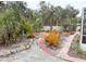 Tropical landscaping with brick pathway and variety of plants in backyard at 5353 Shadow Lawn Dr, Sarasota, FL 34242