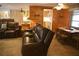 Comfortable living room showcasing wood paneling, tile floors, and an adjacent dining area at 5353 Shadow Lawn Dr, Sarasota, FL 34242