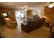 Relaxing living room with wood-paneled walls, tile floors, ceiling fans, patio access and ample seating at 5353 Shadow Lawn Dr, Sarasota, FL 34242