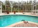 Relaxing screened-in pool area with brick pavers and landscaped surroundings at 5353 Shadow Lawn Dr, Sarasota, FL 34242
