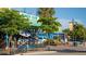 Outdoor restaurant seating shaded by trees, featuring blue accents and a relaxed atmosphere at 5353 Shadow Lawn Dr, Sarasota, FL 34242
