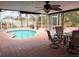 Inviting screened porch features a pool view, brick patio, and a comfortable dining area at 5353 Shadow Lawn Dr, Sarasota, FL 34242