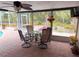 Relaxing screened porch features a dining area with comfortable seating and lush backyard views at 5353 Shadow Lawn Dr, Sarasota, FL 34242