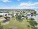 Aerial view showcases waterfront community park featuring a playground, green space, and a serene waterfront setting at 5403 Fleming St, Port Charlotte, FL 33981