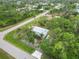 Aerial view showcasing the home's serene location within a quiet neighborhood and mature landscaping at 5403 Fleming St, Port Charlotte, FL 33981