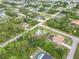 Wide aerial view showing the property's location, surrounded by trees, other homes, and quiet streets at 5403 Fleming St, Port Charlotte, FL 33981
