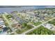 Expansive aerial view of waterfront community with canals, lush landscaping, and a scenic bridge in the distance at 5403 Fleming St, Port Charlotte, FL 33981